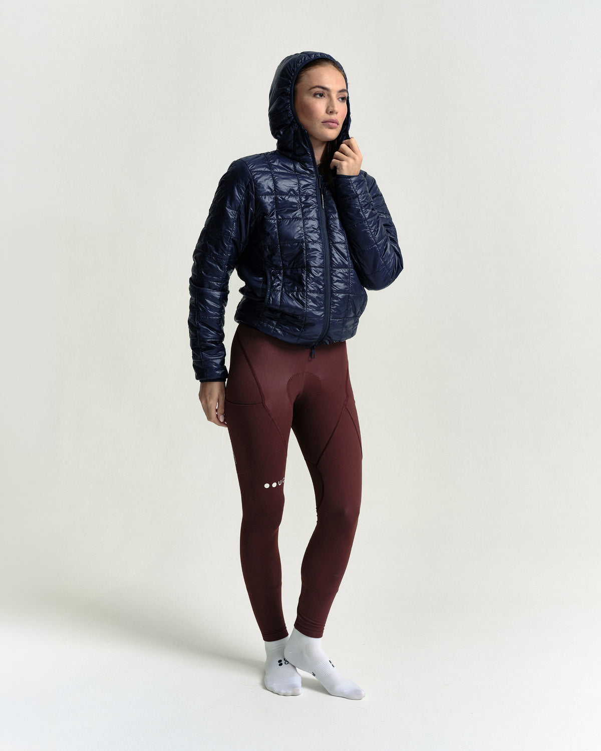 Model wearing the Unisex Insulated Packable Jacket in Ink Blue.