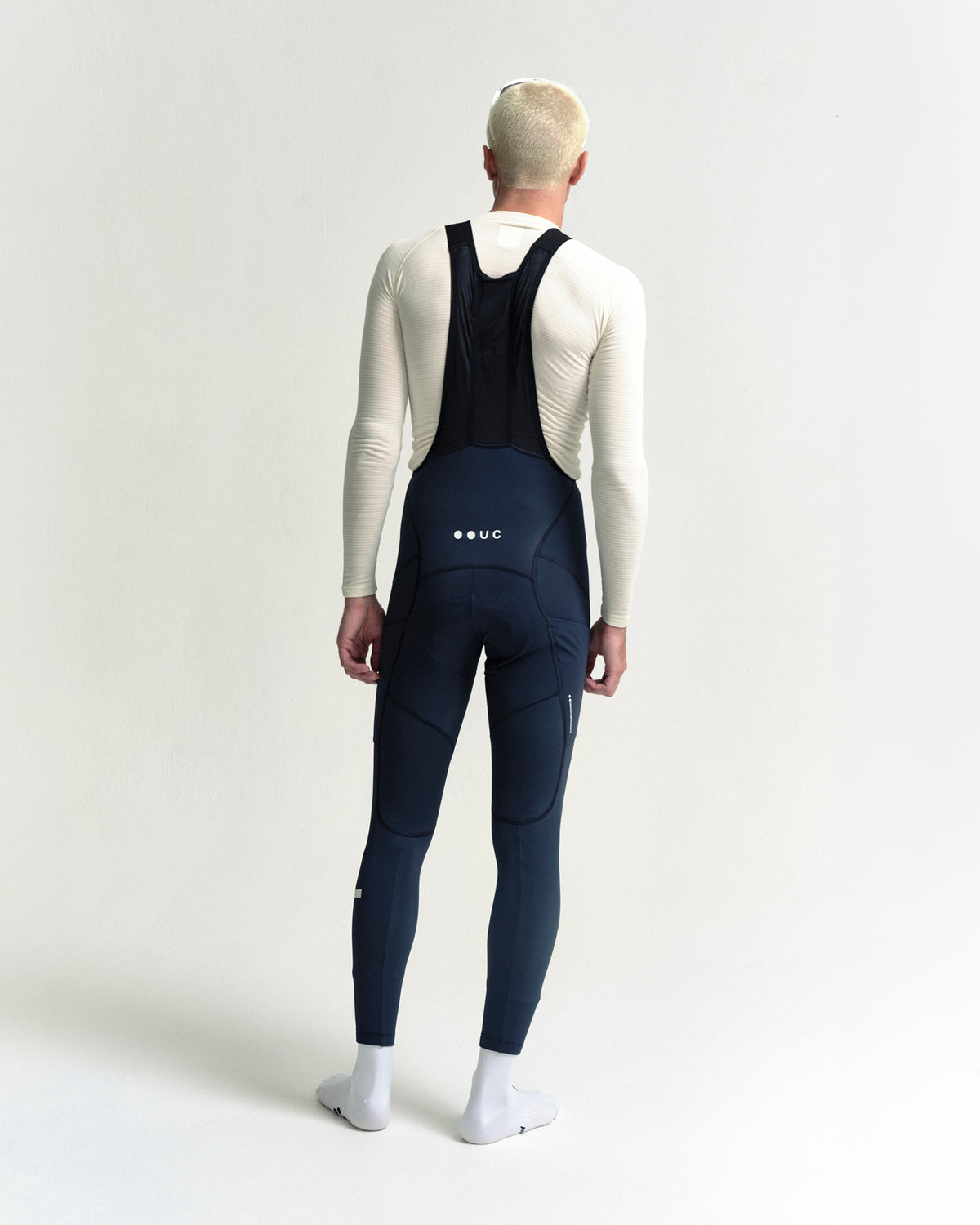 Model wearing the Men's Mono Cargo Bib Tight in Eclipse Navy.
