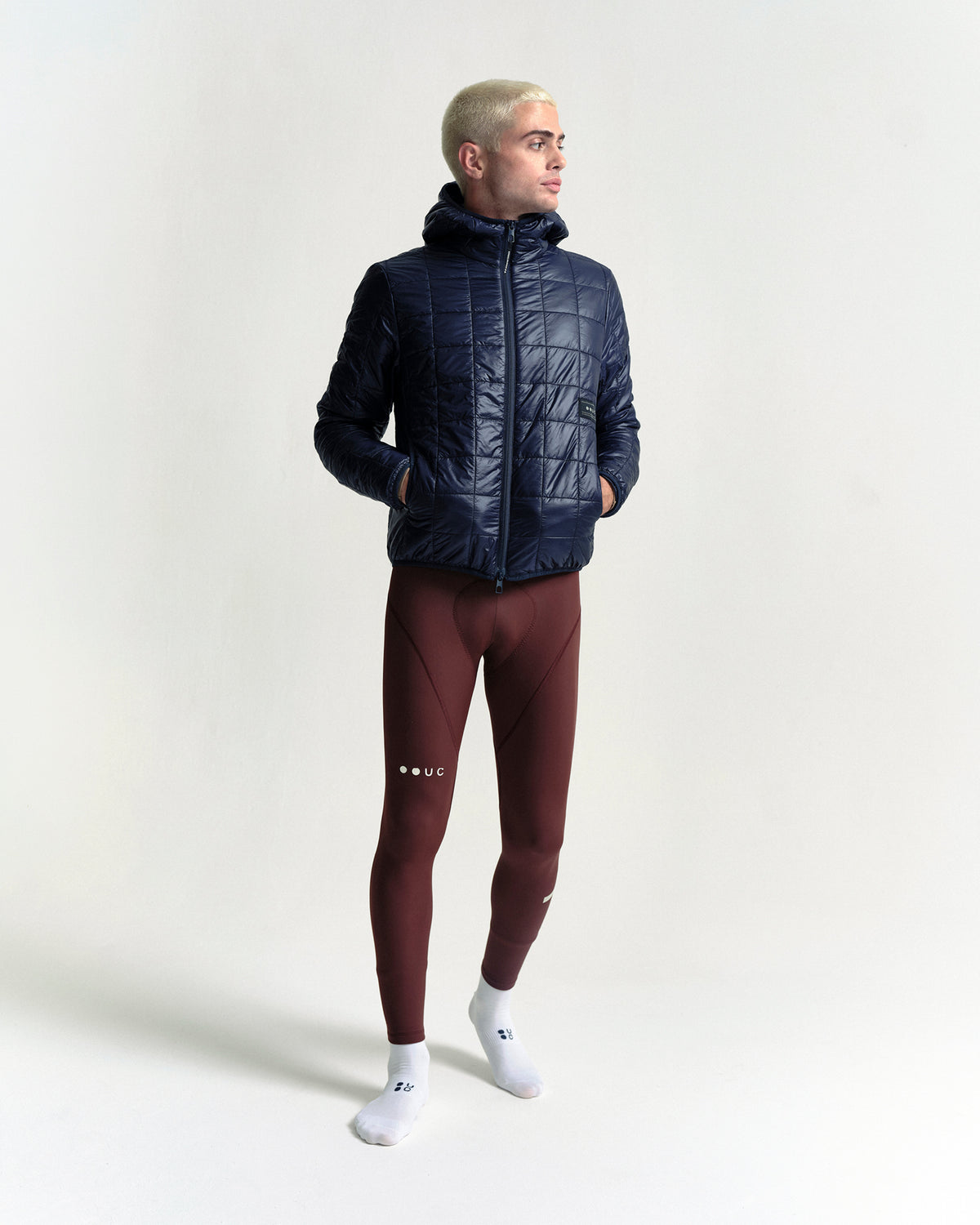 Model wearing the Unisex Insulated Packable Jacket in Ink Blue.