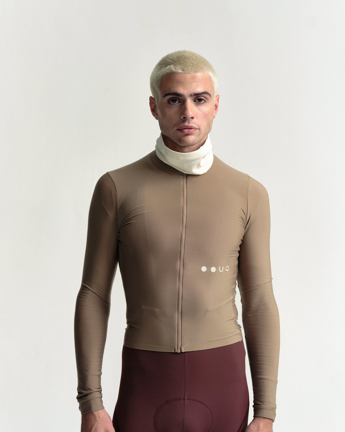 Model wearing the Polartec Neck Warmer in Off White.